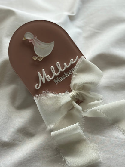 Flip-flop sandal with white ruffle on a white fabric background
