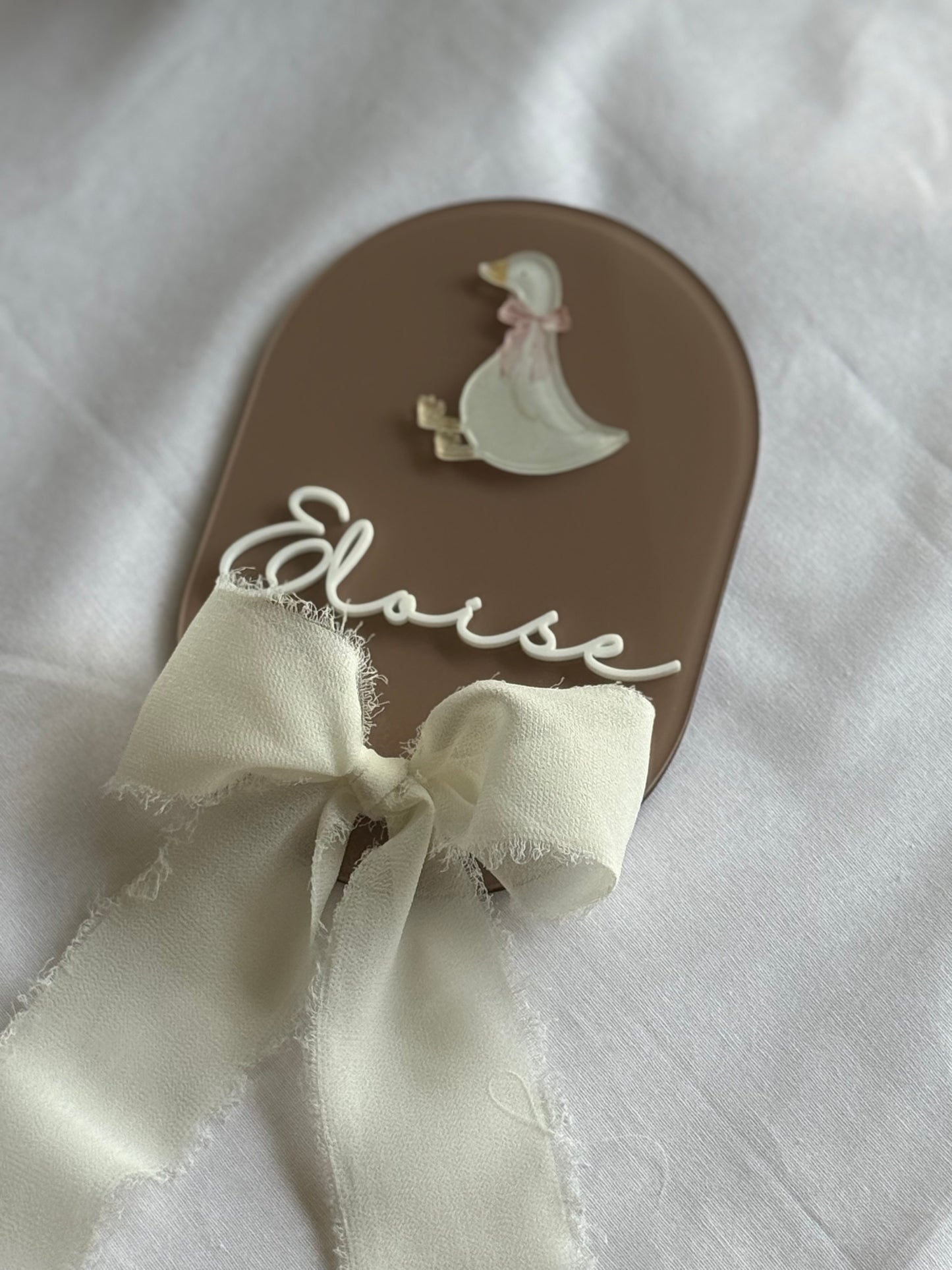 Flip-flop sandal with a white ribbon and 'Elise' branding on a white background
